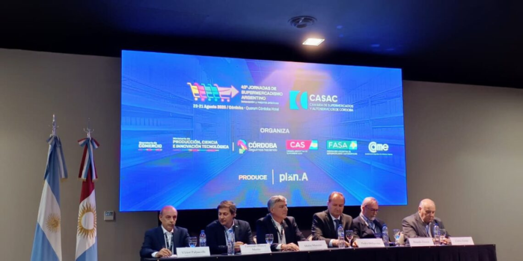 Panel of speakers at the 49th Supermarket and Retail Conference in Córdoba, Argentina, featuring a backdrop with event logos and dates.