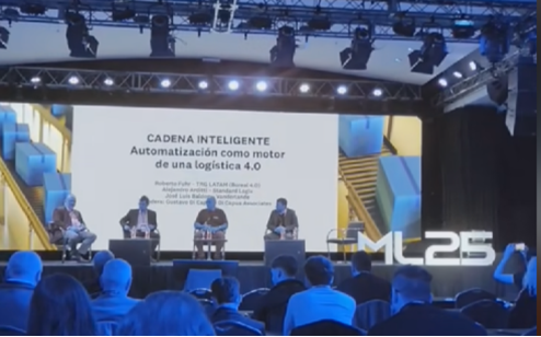 Panel discussion at a logistics conference featuring multiple speakers and a presentation backdrop discussing intelligent supply chains and automation.